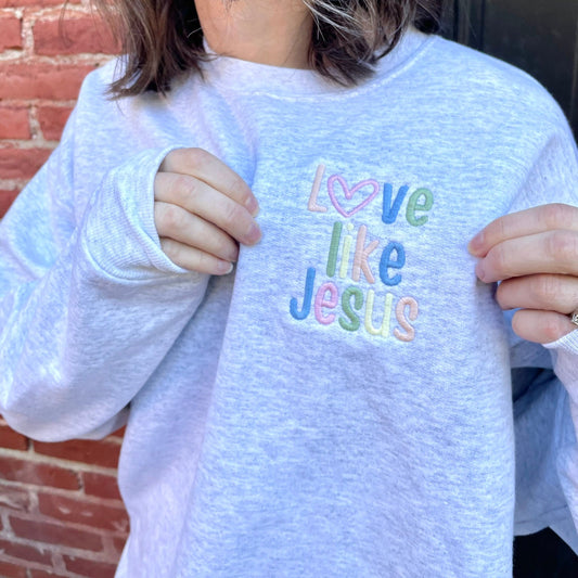 Ash gray crewneck sweatshirt with LOVE LIKE JESUS embroidered in pastels