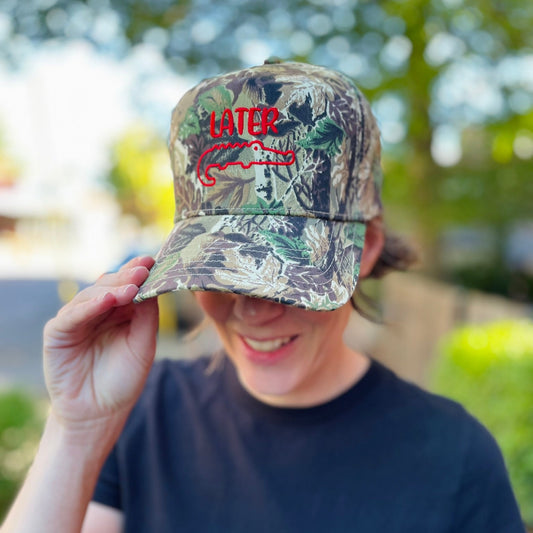 Camouflage hat embroidered with later and image of gator