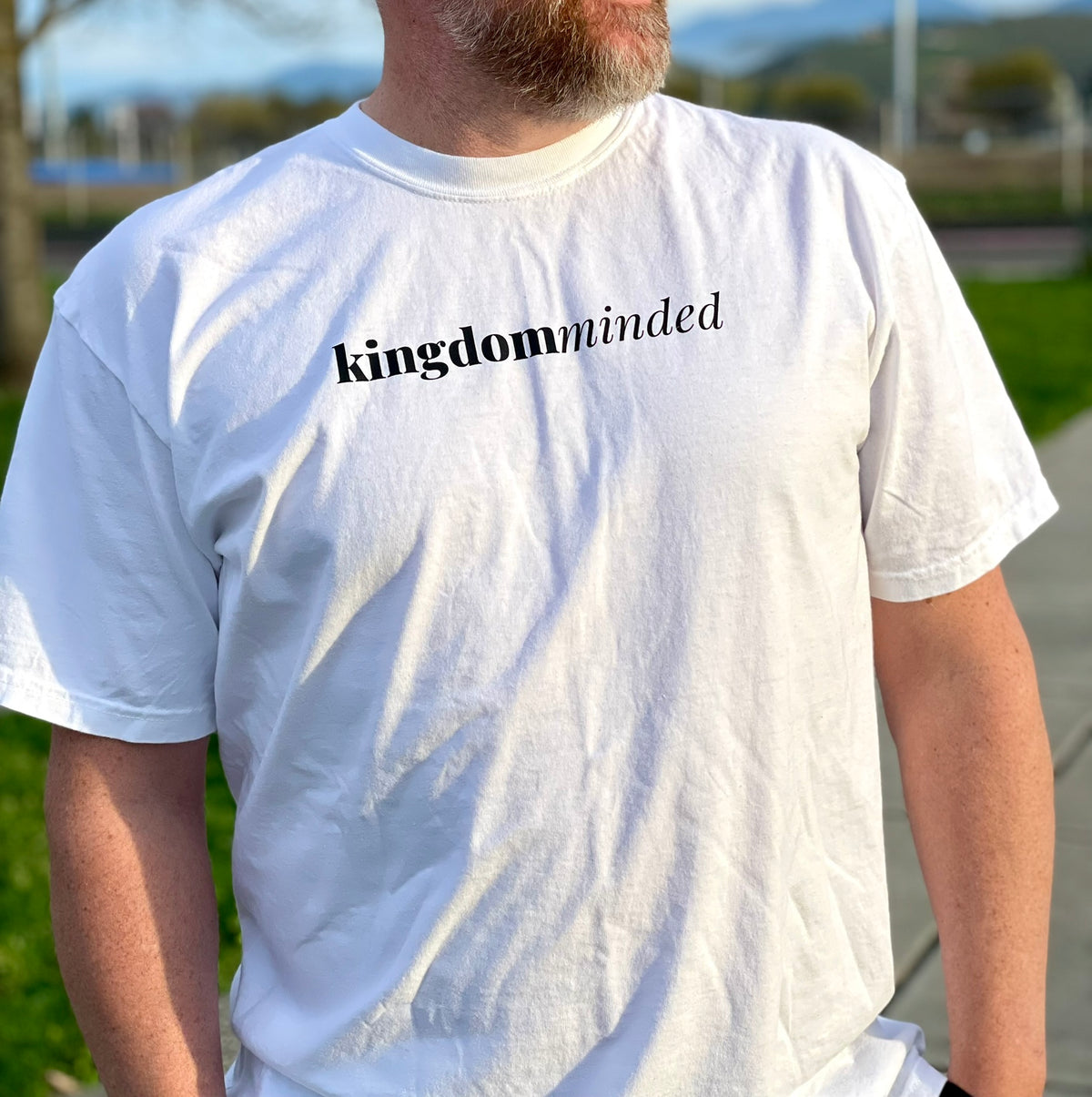 Close up of white tee with kingdom minded on the front