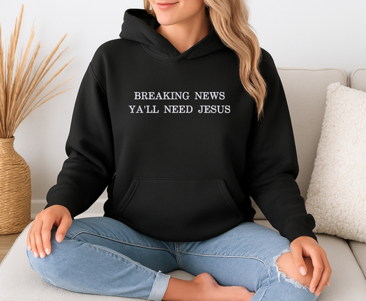 Black hooded sweatshirt with Y'all Need Jesus Embroidered on it in white