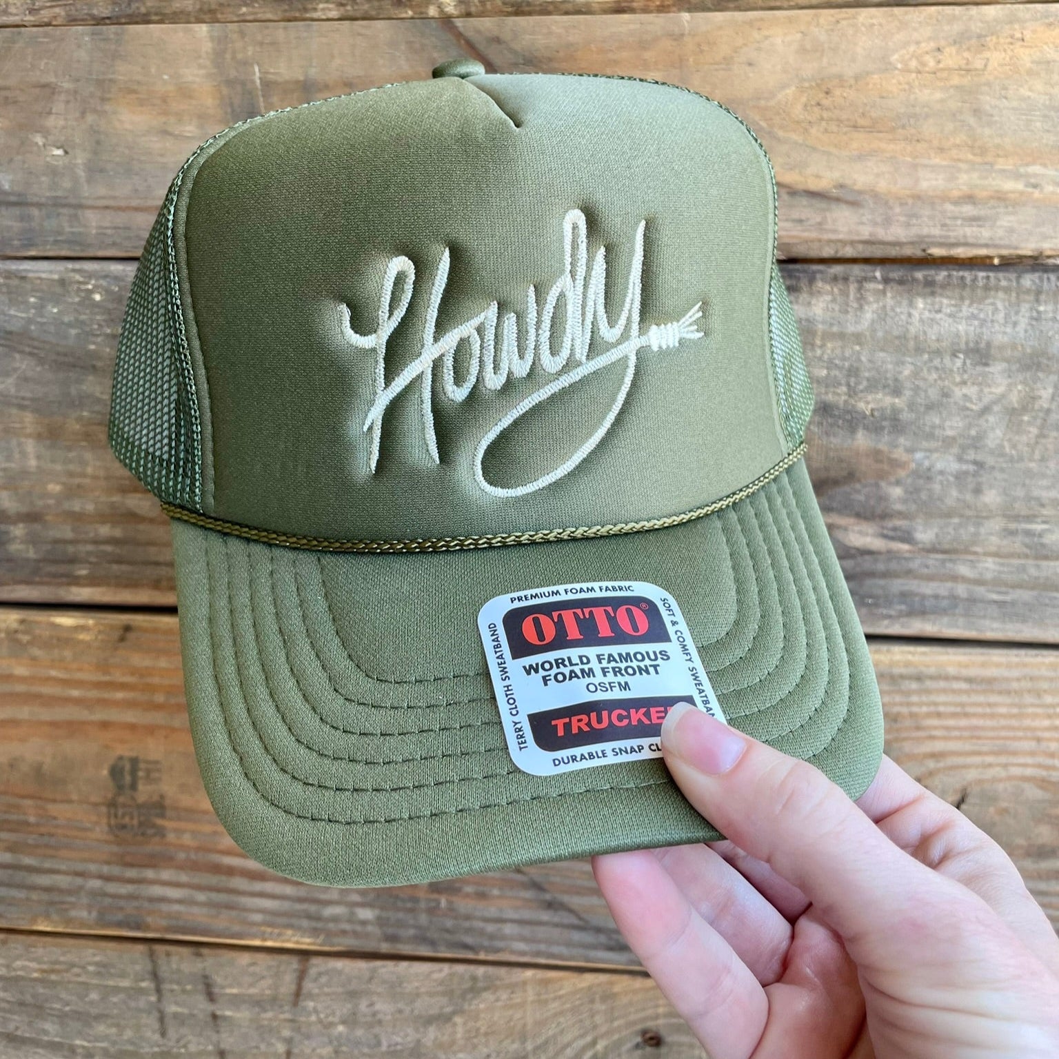 Green trucker hat with 'Howdy' embroidered