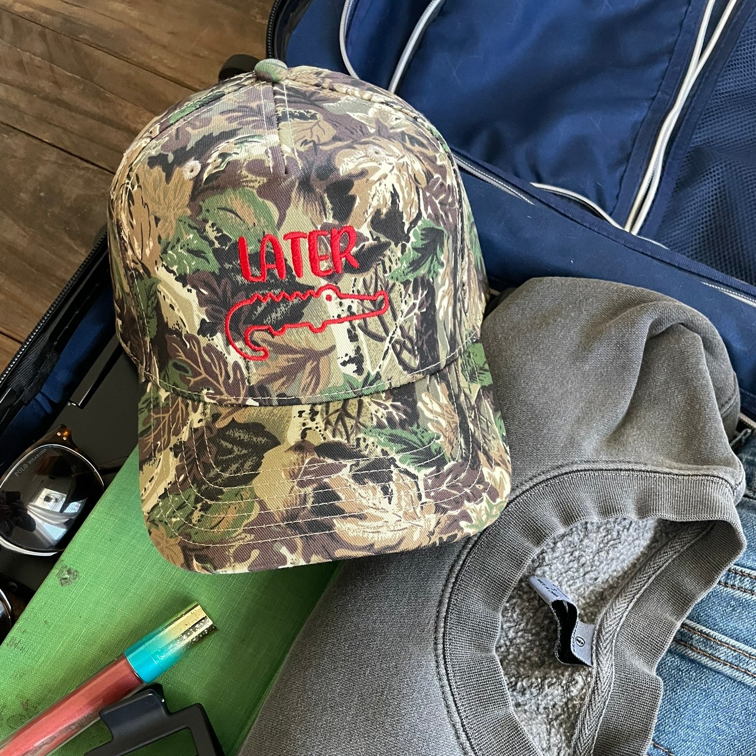 Camouflage hat with red later gator design