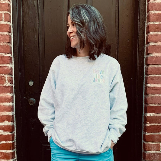 Ash gray crewneck sweatshirt with LOVE LIKE JESUS embroidered in pastels