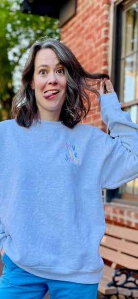Ash gray crewneck sweatshirt with LOVE LIKE JESUS embroidered in pastels