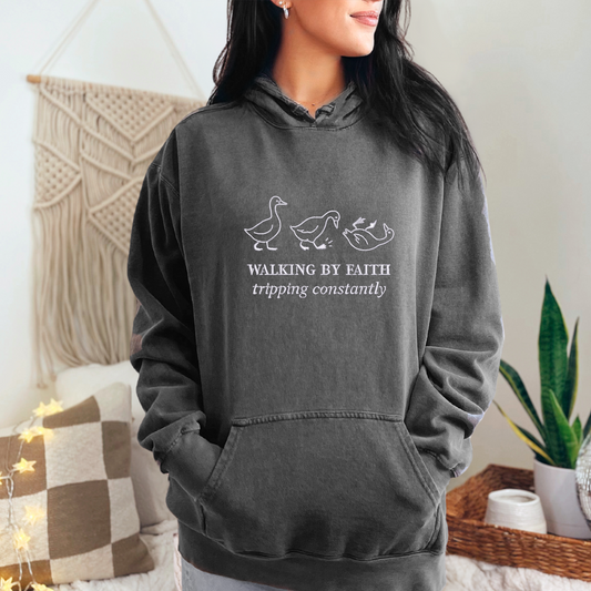 faded black hoodie embroidered with 3 geese and phrase "Walking by Faith tripping constantly"